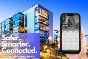A hand holds up a property management app called PropKey. The text on the image says, "safer, smarter, connected". In the background a futuristic building stands tall.