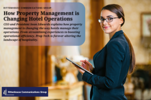 A hotel manager looks at the camera and smiles as she holds an ipad and manages her hotel.