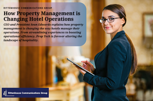 A hotel manager looks at the camera and smiles as she holds an ipad and manages her hotel.